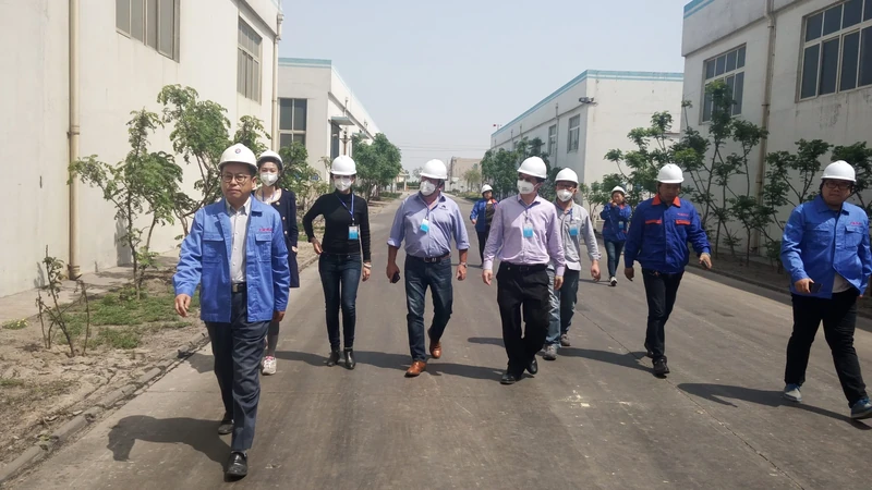 Visitors and TENORCHEM staff walking through the manufacturing site